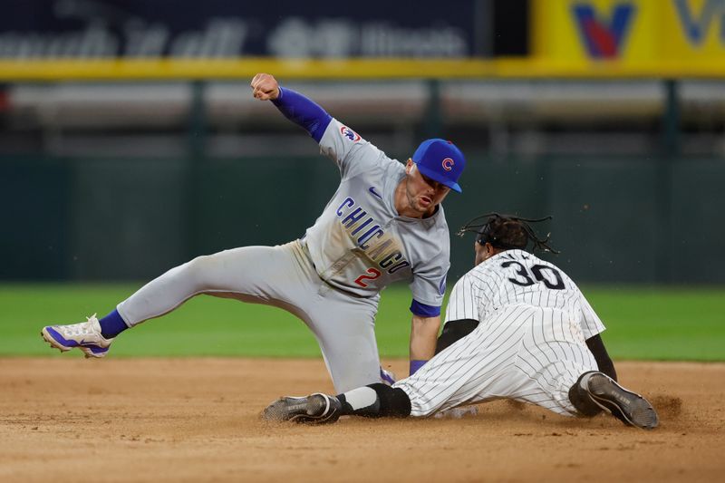 Aug 9, 2024; Chicago, Illinois, USA; Chicago Cubs second baseman Nico Hoerner (2) tags out Chicago White Sox outfielder Corey Julks (30) at second base during the eighth inning at Guaranteed Rate Field. Mandatory Credit: Kamil Krzaczynski-USA TODAY Sports