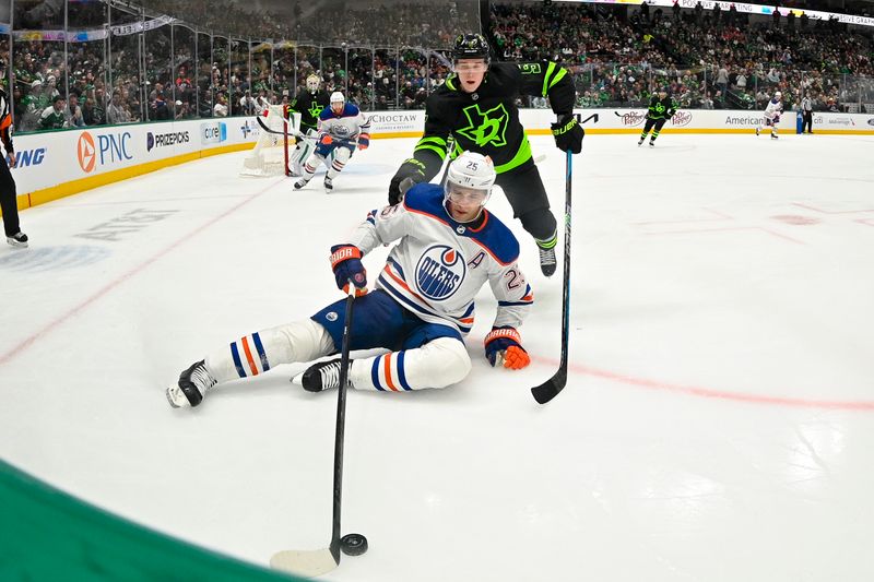 Apr 3, 2024; Dallas, Texas, USA; Dallas Stars defenseman Nils Lundkvist (5) and Edmonton Oilers defenseman Darnell Nurse (25) chase the puck in the Stars zone during the third period at the American Airlines Center. Mandatory Credit: Jerome Miron-USA TODAY Sports