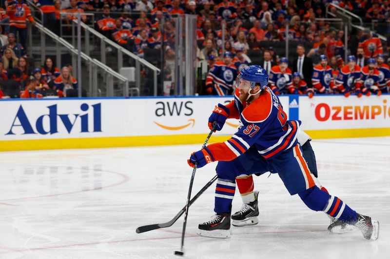 Jun 15, 2024; Edmonton, Alberta, CAN; Edmonton Oilers center Connor McDavid (97) shoots the puck defense by Florida Panthers center Carter Verhaeghe (23) in the second period in game four of the 2024 Stanley Cup Final at Rogers Place. Mandatory Credit: Perry Nelson-USA TODAY Sports