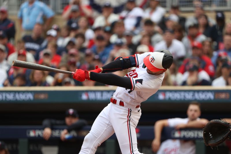 Oct 4, 2023; Minneapolis, Minnesota, USA; Minnesota Twins second baseman Edouard Julien (47) hits a single in the third inning against the Toronto Blue Jays during game two of the Wildcard series for the 2023 MLB playoffs at Target Field. Mandatory Credit: Jesse Johnson-USA TODAY Sports