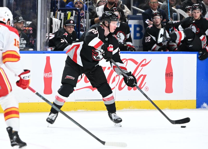 Nov 19, 2025; Buffalo, New York, USA; Buffalo Sabres defenseman Rasmus Dahlin (26) looks to pass the puck against the Calgary Flames in the second period at KeyBank Center. Mandatory Credit: Mark Konezny-Imagn Images