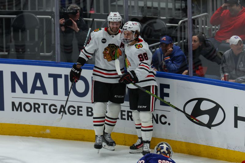 Apr 2, 2024; Elmont, New York, USA; Chicago Blackhawks center Jason Dickinson (16) celebrates his goal with Chicago Blackhawks center Connor Bedard (98) against the New York Islanders during the first period at UBS Arena. Mandatory Credit: Thomas Salus-USA TODAY Sports