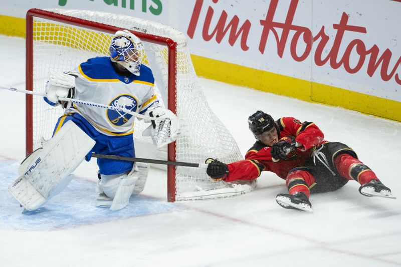 Dec 23, 2025; Ottawa, Ontario, CAN; Ottawa Senators center Tim Stutzle (18) falls on a drive towards Buffalo Sabres goalie Alex Lyon (34) in the third period at the Canadian Tire Centre. Mandatory Credit: Marc DesRosiers-IMAGN Images