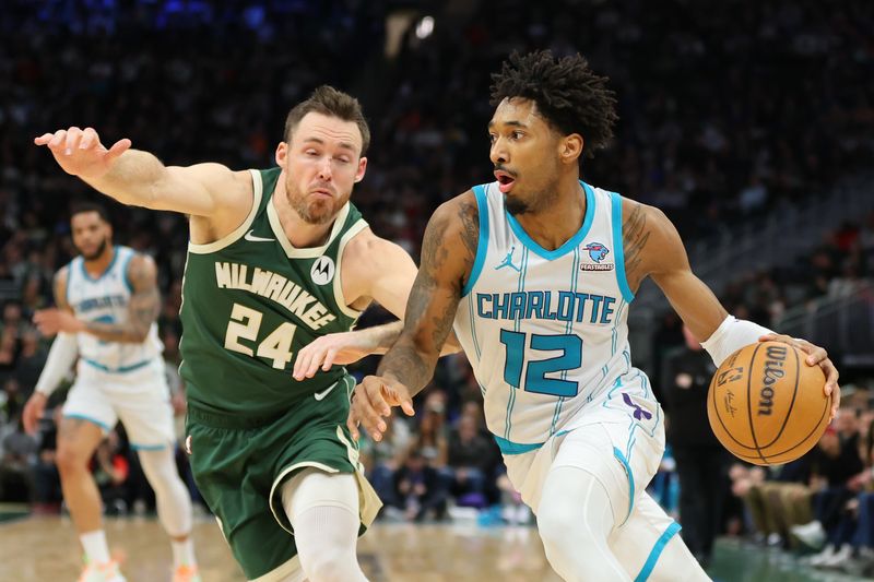 MILWAUKEE, WISCONSIN - FEBRUARY 09: Leaky Black #12 of the Charlotte Hornets drives around Pat Connaughton #24 of the Milwaukee Bucks during a game at Fiserv Forum on February 09, 2024 in Milwaukee, Wisconsin. NOTE TO USER: User expressly acknowledges and agrees that, by downloading and or using this photograph, User is consenting to the terms and conditions of the Getty Images License Agreement. (Photo by Stacy Revere/Getty Images)