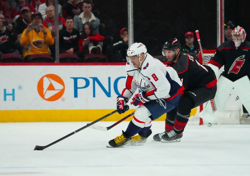 Apr 5, 2024; Raleigh, North Carolina, USA; Washington Capitals left wing Alex Ovechkin (8) skates with the puck past Carolina Hurricanes center Jordan Staal (11) during the second period at PNC Arena. Mandatory Credit: James Guillory-USA TODAY Sports