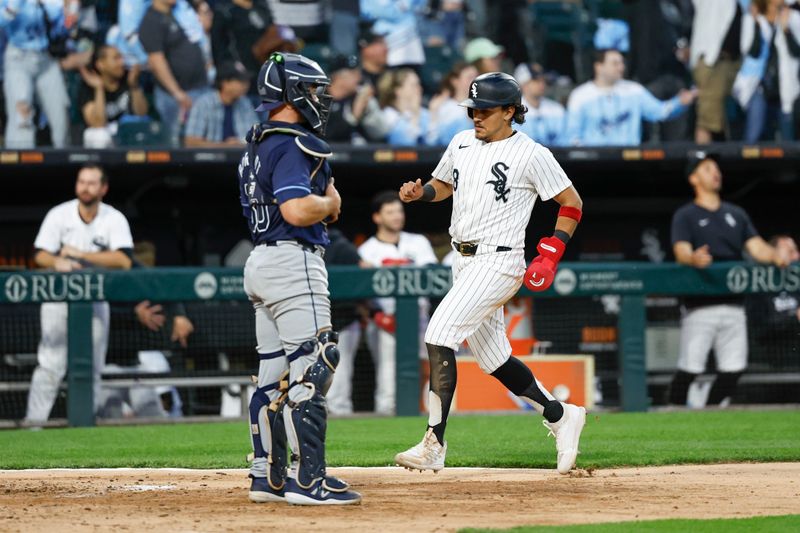 Apr 27, 2024; Chicago, Illinois, USA; Chicago White Sox second baseman Nicky Lopez (8) scores against the Tampa Bay Rays during the fifth inning at Guaranteed Rate Field. Mandatory Credit: Kamil Krzaczynski-USA TODAY Sports