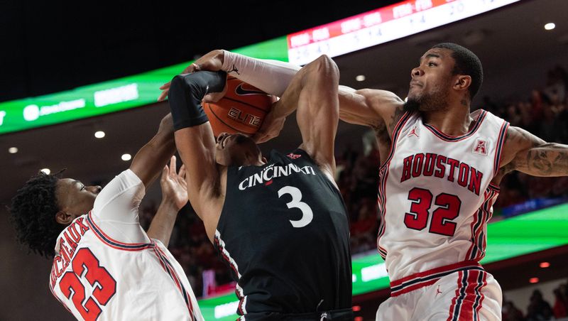 Jan 28, 2023; Houston, Texas, USA; Cincinnati Bearcats guard Mika Adams-Woods (3) shot is blocked by Houston Cougars guard Terrance Arceneaux (23) and forward Reggie Chaney (32) in the second half at Fertitta Center. Houston Cougars won 75-69 .Mandatory Credit: Thomas Shea-USA TODAY Sports