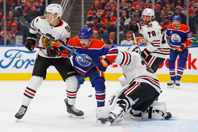 Oct 12, 2024; Edmonton, Alberta, CAN; Edmonton Oilers forward Victor Arvidsson (33) battles with Chicago Blackhawks defensemen TJ Brodie (78) in front of goaltender Petr Mrazek (34) during the first period at Rogers Place. Mandatory Credit: Perry Nelson-Imagn Images