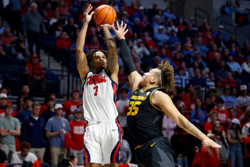 Feb 17, 2024; Oxford, Mississippi, USA; Mississippi Rebels guard Allen Flanigan (7) shoots as Missouri Tigers forward Noah Carter (35) defends during the second half at The Sandy and John Black Pavilion at Ole Miss. Mandatory Credit: Petre Thomas-USA TODAY Sports