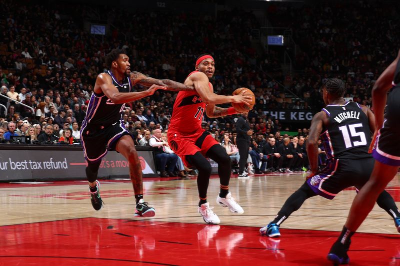 TORONTO, CANADA - MARCH 20: Bruce Brown #11 of the Toronto Raptors drives to the basket during the game against the Sacramento Kings on March 20, 2024 at the Scotiabank Arena in Toronto, Ontario, Canada.  NOTE TO USER: User expressly acknowledges and agrees that, by downloading and or using this Photograph, user is consenting to the terms and conditions of the Getty Images License Agreement.  Mandatory Copyright Notice: Copyright 2024 NBAE (Photo by Vaughn Ridley/NBAE via Getty Images)