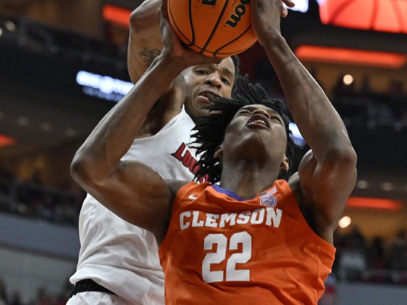 Feb 18, 2023; Louisville, Kentucky, USA;  Louisville Cardinals forward JJ Traynor (12) blocks the shot of Clemson Tigers forward RJ Godfrey (22) during the first half at KFC Yum! Center. Mandatory Credit: Jamie Rhodes-USA TODAY Sports