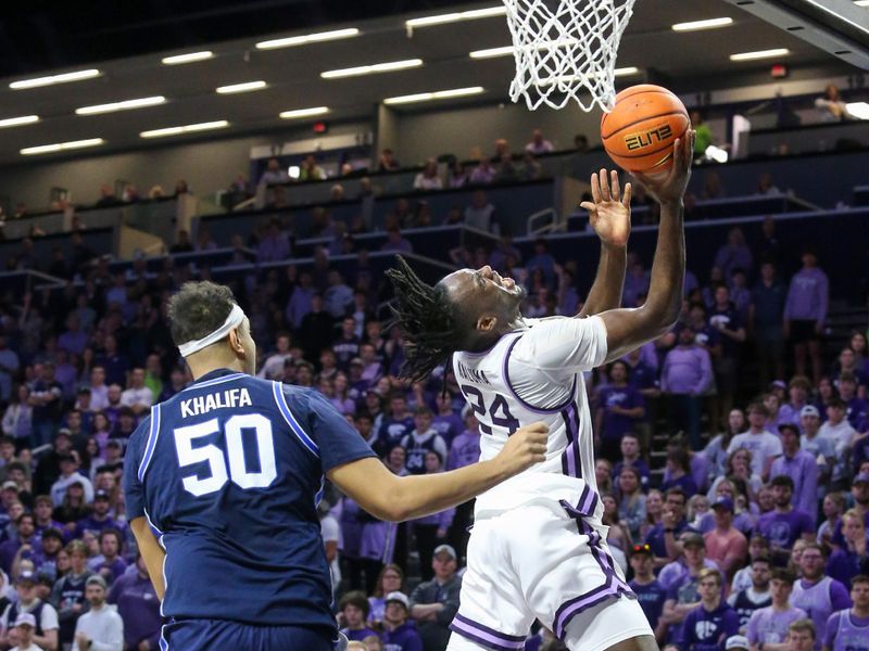 Feb 24, 2024; Manhattan, Kansas, USA; Kansas State Wildcats guard Dai Dai Ames (4) is fouled by Brigham Young Cougars center Aly Khalifa (50) during the first half at Bramlage Coliseum. Mandatory Credit: Scott Sewell-USA TODAY Sports