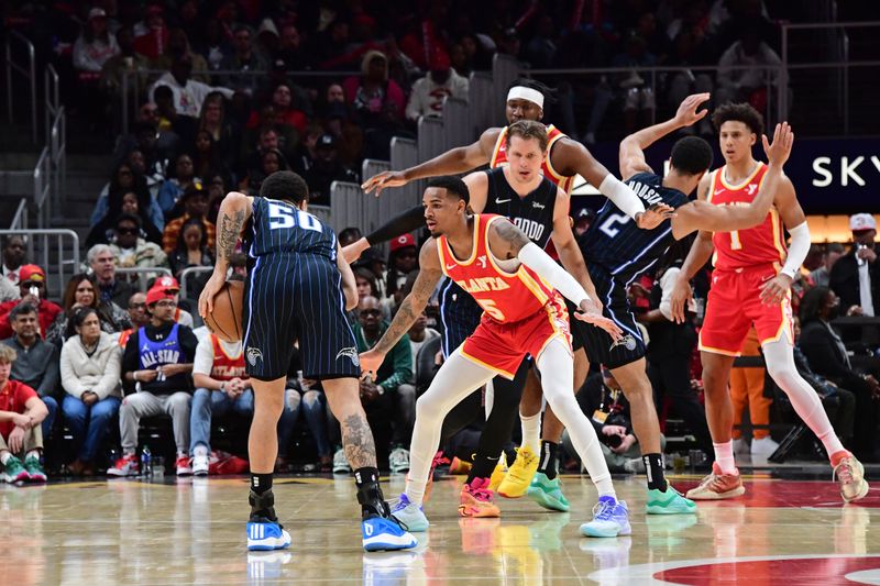 ATLANTA, GA - FEBRUARY 25: Dejounte Murray #5 of the Atlanta Hawks plays defense during the game against the Orlando Magic on February 25, 2024 at State Farm Arena in Atlanta, Georgia.  NOTE TO USER: User expressly acknowledges and agrees that, by downloading and/or using this Photograph, user is consenting to the terms and conditions of the Getty Images License Agreement. Mandatory Copyright Notice: Copyright 2024 NBAE (Photo by Scott Cunningham/NBAE via Getty Images)