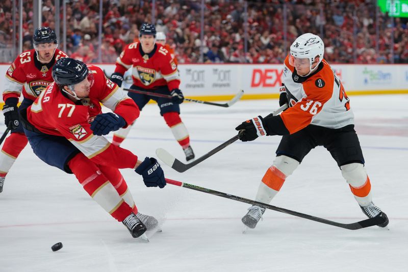 Nov 26, 2025; Sunrise, Florida, USA; Philadelphia Flyers defenseman Emil Andrae (36) shoots the puck against Florida Panthers defenseman Niko Mikkola (77) during the third period at Amerant Bank Arena. Mandatory Credit: Sam Navarro-Imagn Images