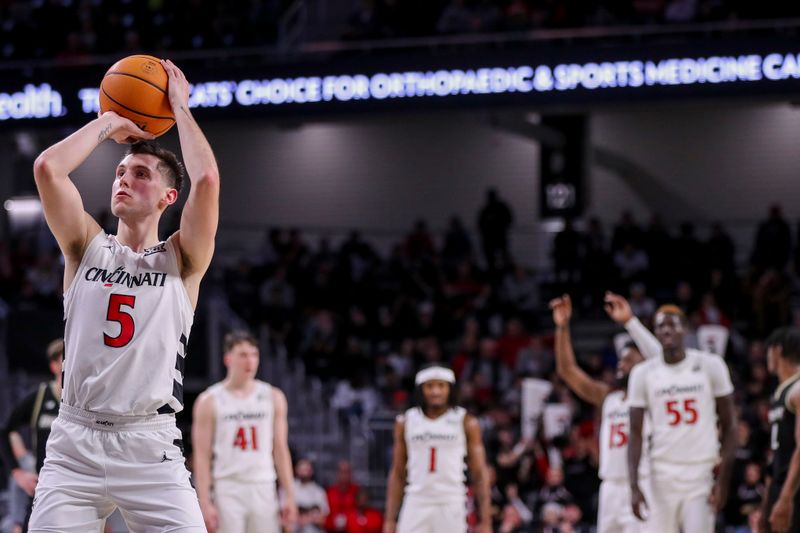 Dec 12, 2023; Cincinnati, Ohio, USA; Cincinnati Bearcats guard CJ Fredrick (5) shoots a technical free throw against the Bryant Bulldogs in the second half at Fifth Third Arena. Mandatory Credit: Katie Stratman-USA TODAY Sports