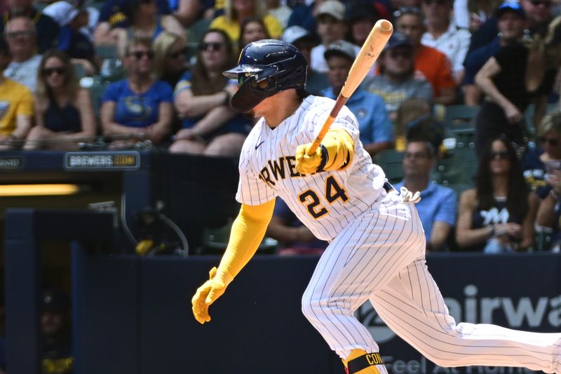 May 28, 2023; Milwaukee, Wisconsin, USA;  Milwaukee Brewers catcher William Contreras (24) hits an RBI single in the first inning against the San Francisco Giants at American Family Field. Mandatory Credit: Benny Sieu-USA TODAY Sports