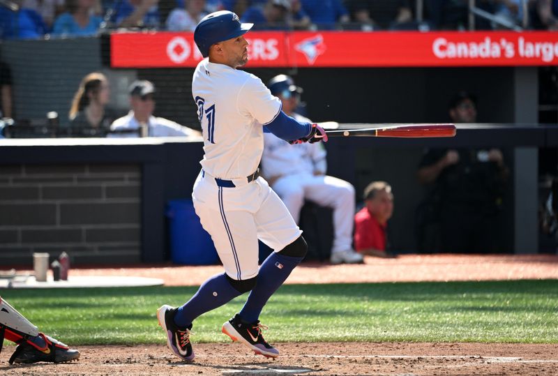 Sep 15, 2024; Toronto, Ontario, CAN;  Toronto Blue Jays pinch hitter George Springer (4) hits a single against the St. Louis Cardinals in the eighth inning at Rogers Centre. Mandatory Credit: Dan Hamilton-Imagn Images