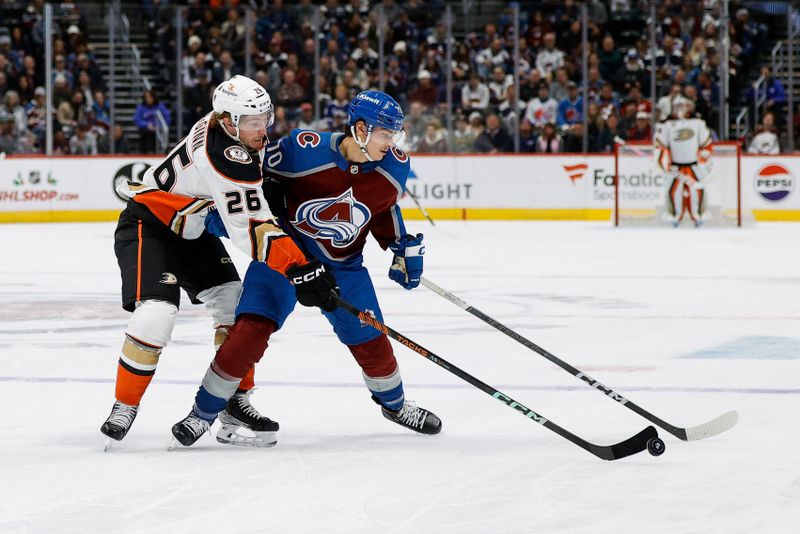 Dec 5, 2023; Denver, Colorado, USA; Anaheim Ducks left wing Brock McGinn (26) and Colorado Avalanche defenseman Sam Malinski (70) battle for the puck in the first period at Ball Arena. Mandatory Credit: Isaiah J. Downing-USA TODAY Sports