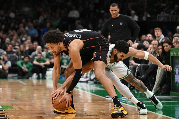 BOSTON, MASSACHUSETTS - DECEMBER 28: Jayson Tatum #0 of the Boston Celtics reaches for a ball against Cade Cunningham #2 of the Detroit Pistons during the fourth quarter at TD Garden on December 28, 2023 in Boston, Massachusetts. NOTE TO USER: User expressly acknowledges and agrees that, by downloading and or using this photograph, User is consenting to the terms and conditions of the Getty Images License Agreement. (Photo by Brian Fluharty/Getty Images)