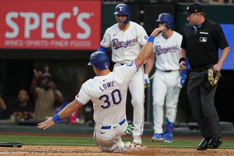 Sep 7, 2024; Arlington, Texas, USA; Texas Rangers first baseman Nathaniel Lowe (30) slides to score on a double hit by Texas Rangers left fielder Ezequiel Duran (not shown) during the fifth inning against the Los Angeles Angels at Globe Life Field. Mandatory Credit: Jim Cowsert-Imagn Images