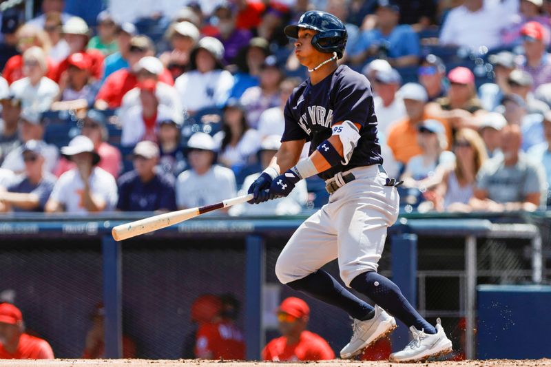 Mar 22, 2023; West Palm Beach, Florida, USA; New York Yankees third baseman Oswaldo Cabrera (95) hits a single during the second inning against the Washington Nationals at The Ballpark of the Palm Beaches. Mandatory Credit: Sam Navarro-USA TODAY Sports