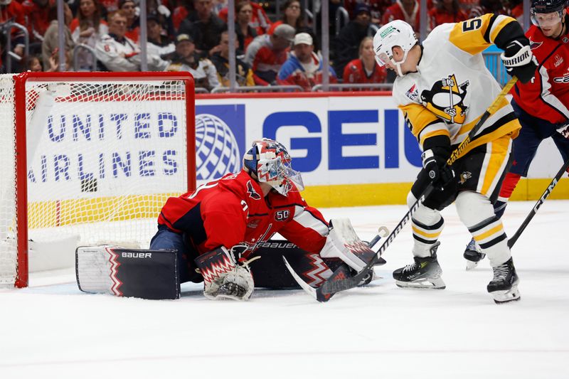 Nov 8, 2024; Washington, District of Columbia, USA; Washington Capitals goaltender Charlie Lindgren (79) makes a save on Pittsburgh Penguins center Noel Acciari (55) in the second period at Capital One Arena. Mandatory Credit: Geoff Burke-Imagn Images