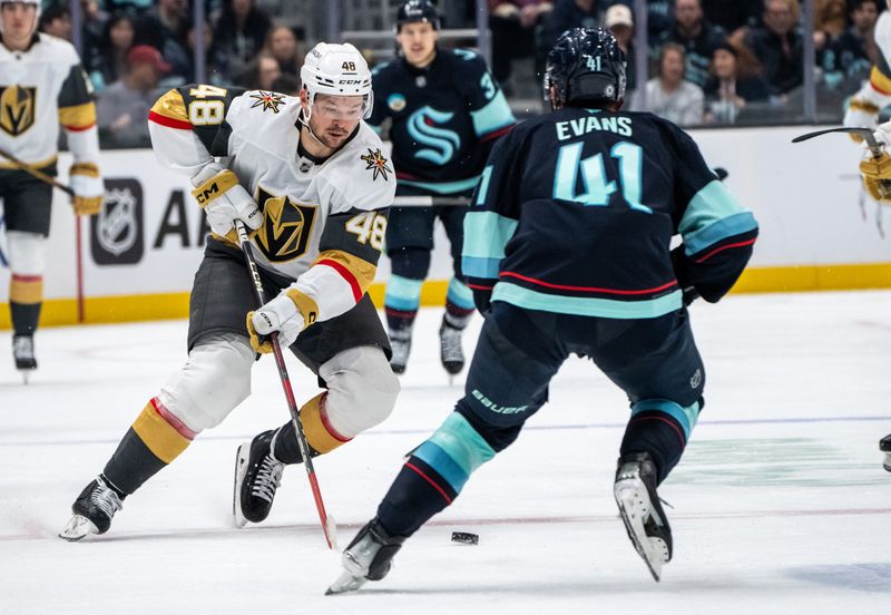 Nov 8, 2024; Seattle, Washington, USA;  Vegas Golden Knights forward Tomas Hertl (48) skates against Seattle Kraken defenseman Ryker Evans (41) during the third period at Climate Pledge Arena. Mandatory Credit: Stephen Brashear-Imagn Images