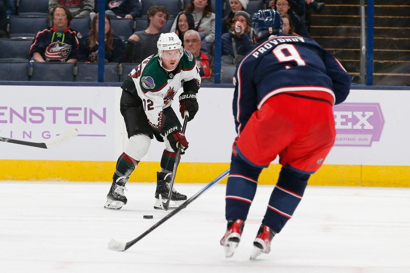 Nov 16, 2023; Columbus, Ohio, USA; Arizona Coyotes center Travis Boyd (72) looks to pass as Columbus Blue Jackets defenseman Ivan Provorov (9) defends during the third period at Nationwide Arena. Mandatory Credit: Russell LaBounty-USA TODAY Sports