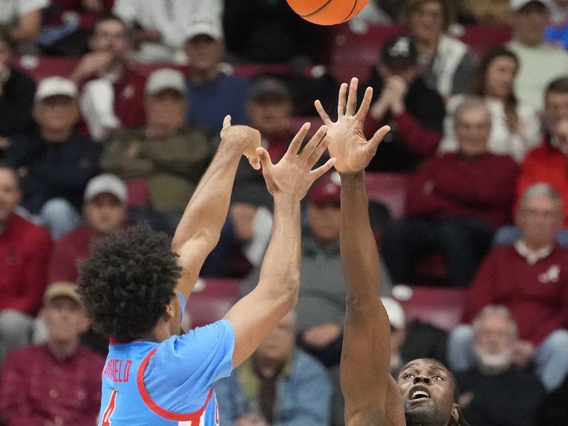 Jan 14, 2025; Tuscaloosa, AL, USA; Alabama center Clifford Omoruyi (11) defends a shot by Ole Miss forward Jaemyn Brakefield (4) at Coleman Coliseum. Mandatory Credit: Gary Cosby Jr.-USA TODAY Network via Imagn Images