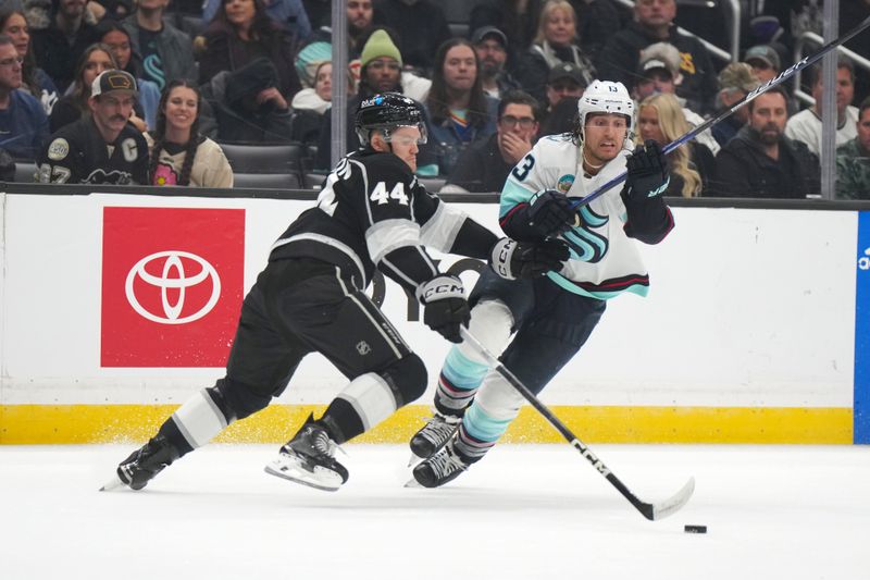 Dec 20, 2023; Los Angeles, California, USA; LA Kings defenseman Mikey Anderson (44) and Seattle Kraken left wing Brandon Tanev (13) battle for the puck in the first period at Crypto.com Arena. Mandatory Credit: Kirby Lee-USA TODAY Sports