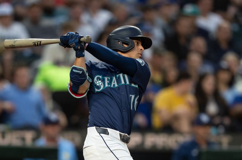 Aug 26, 2024; Seattle, Washington, USA; Seattle Mariners shortstop Leo Rivas (76) hits a RBI-single during the fourth inning against the Tampa Bay Rays at T-Mobile Park. Mandatory Credit: Stephen Brashear-USA TODAY Sports