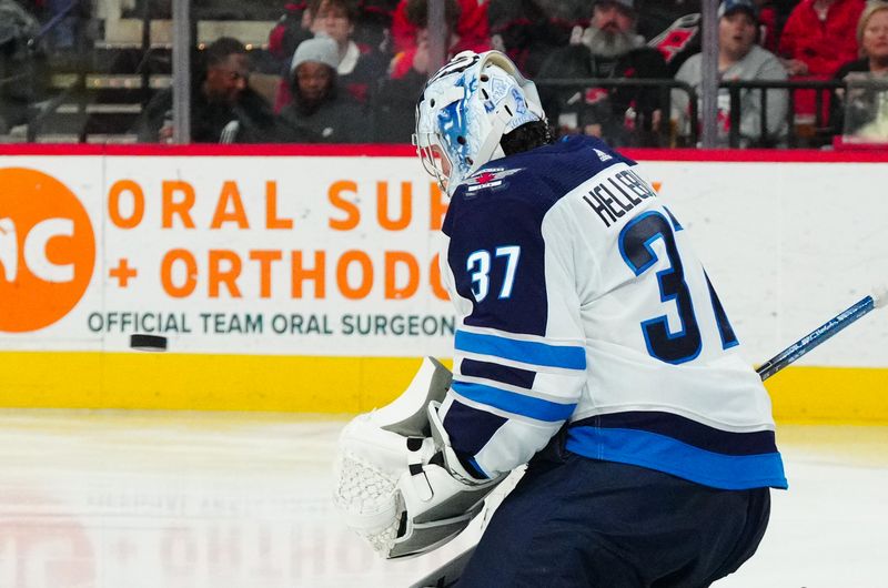 Mar 2, 2024; Raleigh, North Carolina, USA; Winnipeg Jets goaltender Connor Hellebuyck (37) makes a save against the Carolina Hurricanes during the third period at PNC Arena. Mandatory Credit: James Guillory-USA TODAY Sports