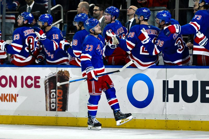 Oct 12, 2024; New York, New York, USA; New York Rangers defenseman Adam Fox (23) celebrates with teammates after scoring a goal against the Utah Hockey Club during the third period at Madison Square Garden. Mandatory Credit: John Jones-Imagn Images