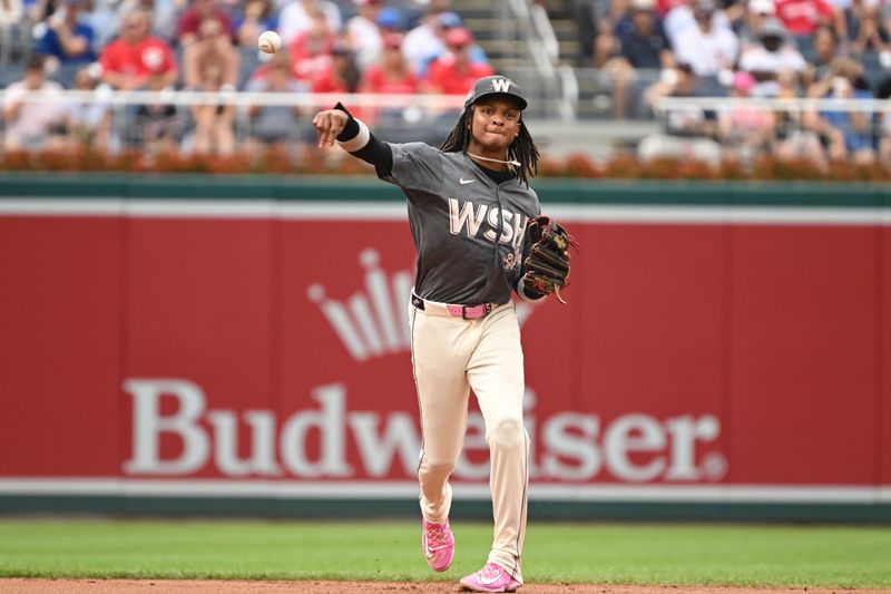 Aug 31, 2024; Washington, District of Columbia, USA; Washington Nationals shortstop CJ Abrams (5) attempts a throw to first base against the Chicago Cubs during the first inning at Nationals Park. Mandatory Credit: Rafael Suanes-USA TODAY Sports