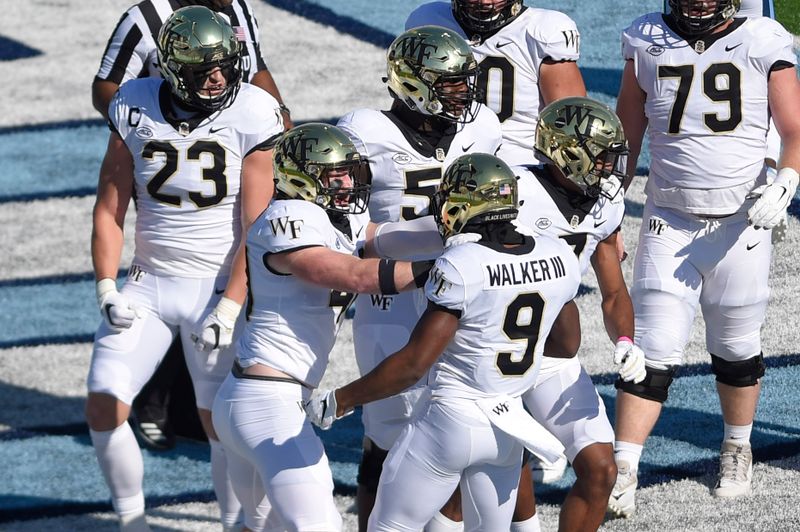 Nov 14, 2020; Chapel Hill, North Carolina, USA; Wake Forest Demon Deacons running back Kenneth Walker III (9) celebrates with tight end Connor Hebbeler (40) after scoring a touchdown in the first quarter at Kenan Memorial Stadium. Mandatory Credit: Bob Donnan-USA TODAY Sports