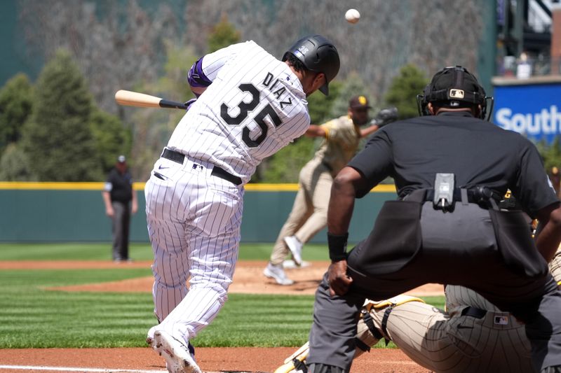 Apr 25, 2024; Denver, Colorado, USA; Colorado Rockies designated hitter Elias Díaz (35) RBI singles in the first inning against the San Diego Padres at Coors Field. Mandatory Credit: Ron Chenoy-USA TODAY Sports