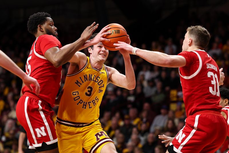 Jan 24, 2026; Minneapolis, Minnesota, USA; Minnesota Golden Gophers forward Bobby Durkin (3) drives towards the basket as Nebraska Cornhuskers forward Jared Garcia (15) and guard Cale Jacobsen (31) defend during the first half at Williams Arena. Mandatory Credit: Matt Krohn-Imagn Images
