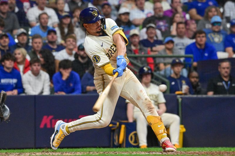 May 29, 2024; Milwaukee, Wisconsin, USA; Milwaukee Brewers shortstop Willy Adames (27) hits a 2-run home run in the seventh inning against the Chicago Cubs at American Family Field. Mandatory Credit: Benny Sieu-USA TODAY Sports