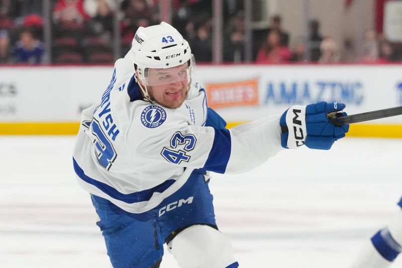 Feb 26, 2026; Raleigh, North Carolina, USA;  Tampa Bay Lightning defenseman Darren Raddysh (43) takes a shot against the Carolina Hurricanes during the second period at Lenovo Center. Mandatory Credit: James Guillory-Imagn Images