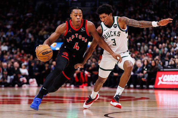TORONTO, CANADA - NOVEMBER 15: Scottie Barnes #4 of the Toronto Raptors drives against MarJon Beauchamp #3 of the Milwaukee Bucks during the first half of their NBA game at Scotiabank Arena on November 15, 2023 in Toronto, Canada. NOTE TO USER: User expressly acknowledges and agrees that, by downloading and or using this photograph, User is consenting to the terms and conditions of the Getty Images License Agreement. (Photo by Cole Burston/Getty Images)