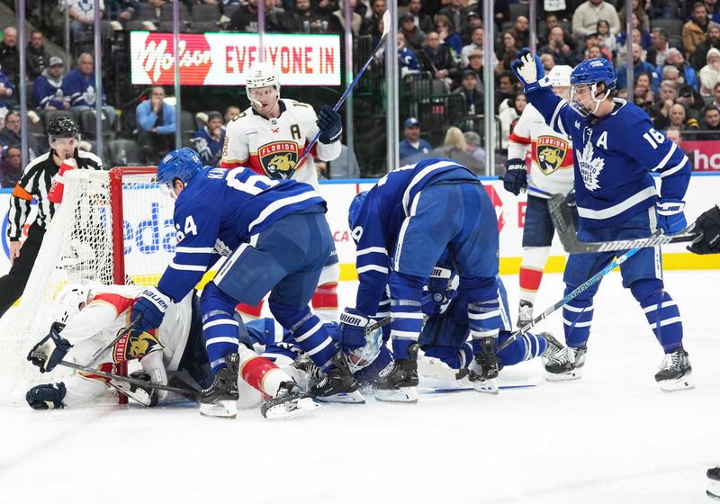 Nov 28, 2023; Toronto, Ontario, CAN; Toronto Maple Leafs center David Kampf (64) battles in front of the net against the Florida Panthers during the second period at Scotiabank Arena. Mandatory Credit: Nick Turchiaro-USA TODAY Sports