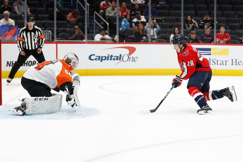 Sep 22, 2024; Washington, District of Columbia, USA; Washington Capitals forward Andrew Cristall (28) takes a shot on Philadelphia Flyers goaltender Carson Bjarnason (64) in a shootout at Capital One Arena. Mandatory Credit: Geoff Burke-Imagn Images