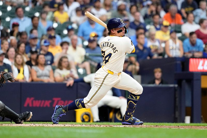 Jul 9, 2024; Milwaukee, Wisconsin, USA;  Milwaukee Brewers designated hitter William Contreras (24) hits an RBI double during the third inning against the Pittsburgh Pirates at American Family Field. Mandatory Credit: Jeff Hanisch-USA TODAY Sports