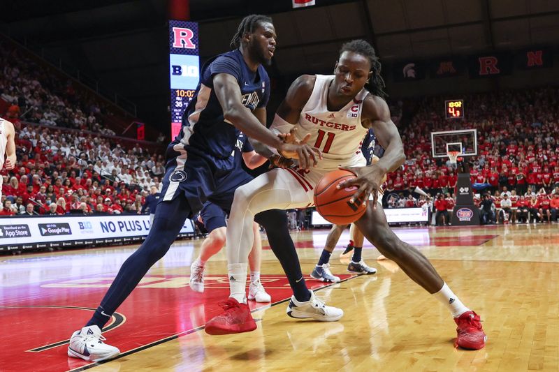 Jan 31, 2024; Piscataway, New Jersey, USA; Rutgers Scarlet Knights center Clifford Omoruyi (11) dribbles against Penn State Nittany Lions forward Qudus Wahab (22) during the second half at Jersey Mike's Arena. Mandatory Credit: Vincent Carchietta-USA TODAY Sports