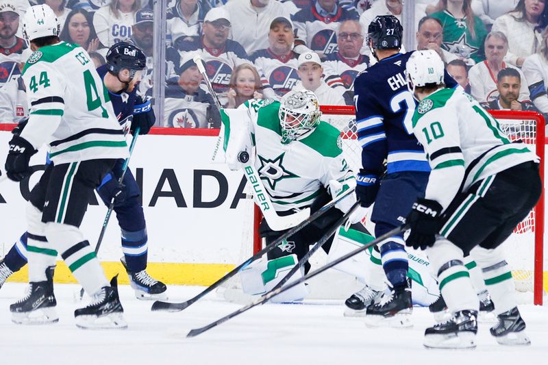 May 7, 2025; Winnipeg, Manitoba, CAN; Dallas Stars goalie Jake Oettinger (29) makes a save as Winnipeg Jets forward Nikolaj Ehlers (27) looks for a rebound during the first period in game one of the second round of the 2025 Stanley Cup Playoffs at Canada Life Centre. Mandatory Credit: Terrence Lee-Imagn Images