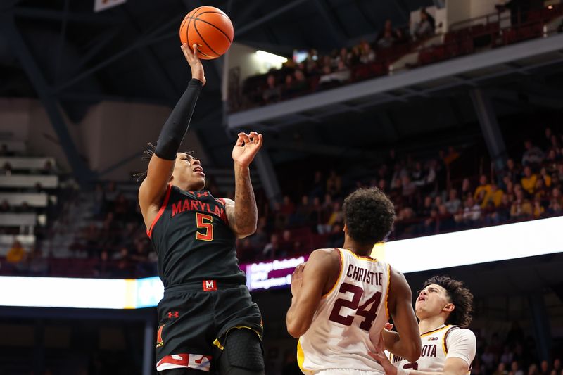 Jan 7, 2024; Minneapolis, Minnesota, USA; Maryland Terrapins guard DeShawn Harris-Smith (5) shoots as Minnesota Golden Gophers guard Cam Christie (24) defends during the second half at Williams Arena. Mandatory Credit: Matt Krohn-USA TODAY Sports