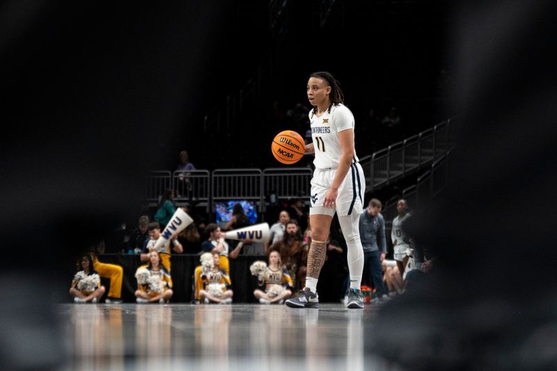 Mar 7, 2025; Kansas City, MO, USA; West Virginia Mountaineers guard JJ Quinerly (11) handles the ball against the Kansas State Wildcats in the second quarter at T-Mobile Center. Mandatory Credit: Amy Kontras-Imagn Images