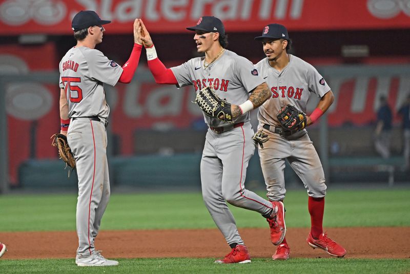 Aug 5, 2024; Kansas City, Missouri, USA;  Boston Red Sox players Boston Red Sox left fielder Jarren Duran (center), second baseman Nick Sogard (left) and shortstop David Hamilton (right) celebrate after beating the Kansas City Royals at Kauffman Stadium. Mandatory Credit: Peter Aiken-USA TODAY Sports