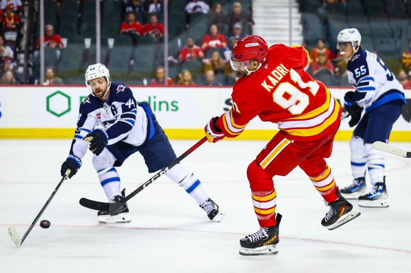 Oct 3, 2025; Calgary, Alberta, CAN; Calgary Flames center Nazem Kadri (91) shoots the puck against the Winnipeg Jets during the overtime period at Scotiabank Saddledome. Mandatory Credit: Sergei Belski-Imagn Images