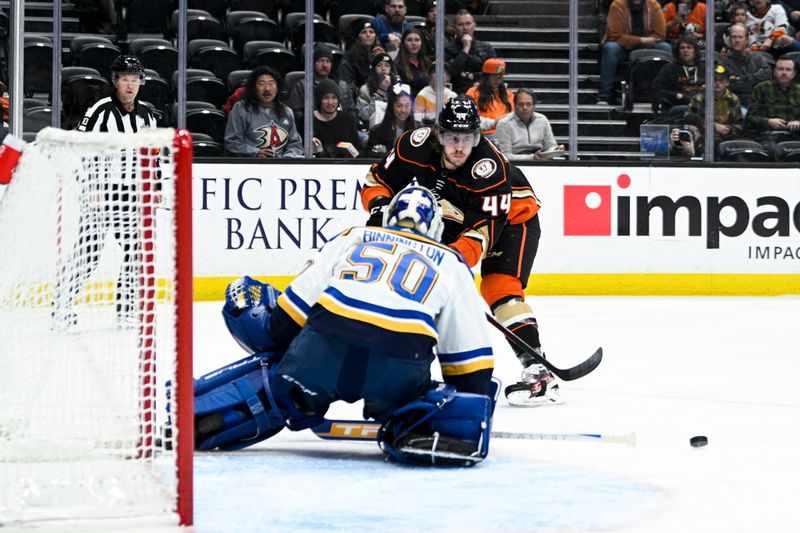 Mar 25, 2023; Anaheim, California, USA; Anaheim Ducks left wing Max Comtois (44) passes the puck while St. Louis Blues goalie Jordan Binnington (50) defends the goal during first period at Honda Center. Mandatory Credit: Kelvin Kuo-USA TODAY Sports